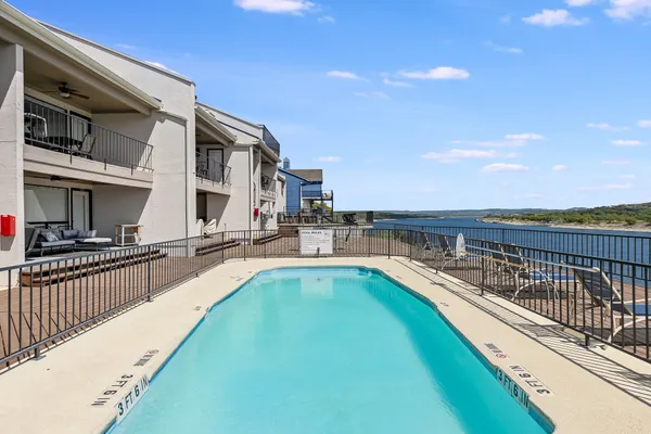 a view of a swimming pool with a lounge chair