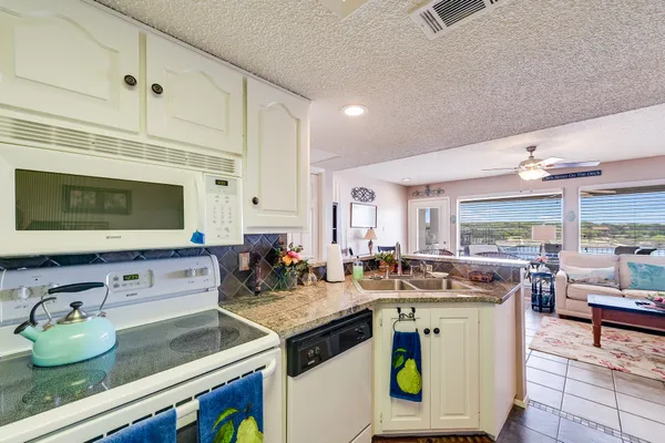 a kitchen with a sink stove and cabinets