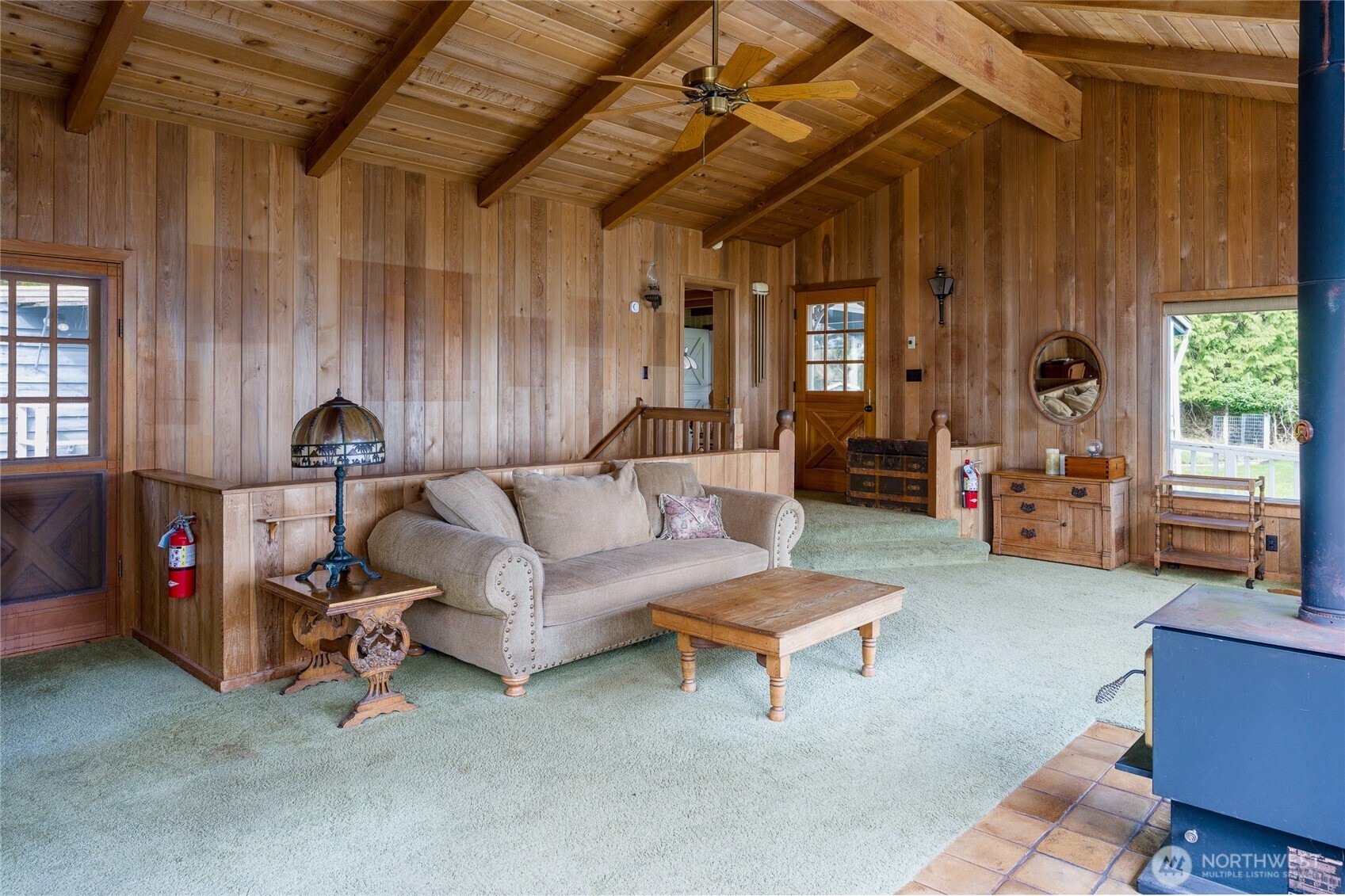 208 Tides End Road Lopez Island, WA 98261 - Photo 13 of 40 a living room with furniture and a fireplace