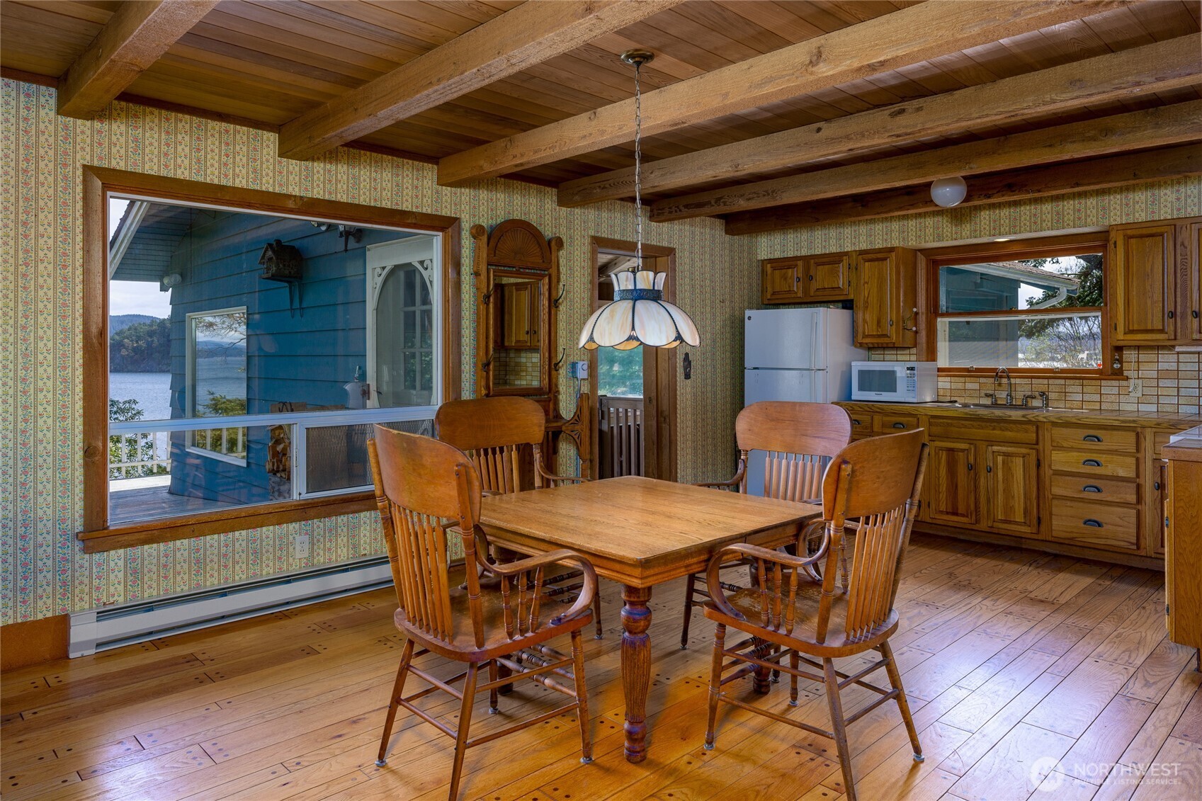 208 Tides End Road Lopez Island, WA 98261 - Photo 15 of 40 a dining room with furniture and wooden floor