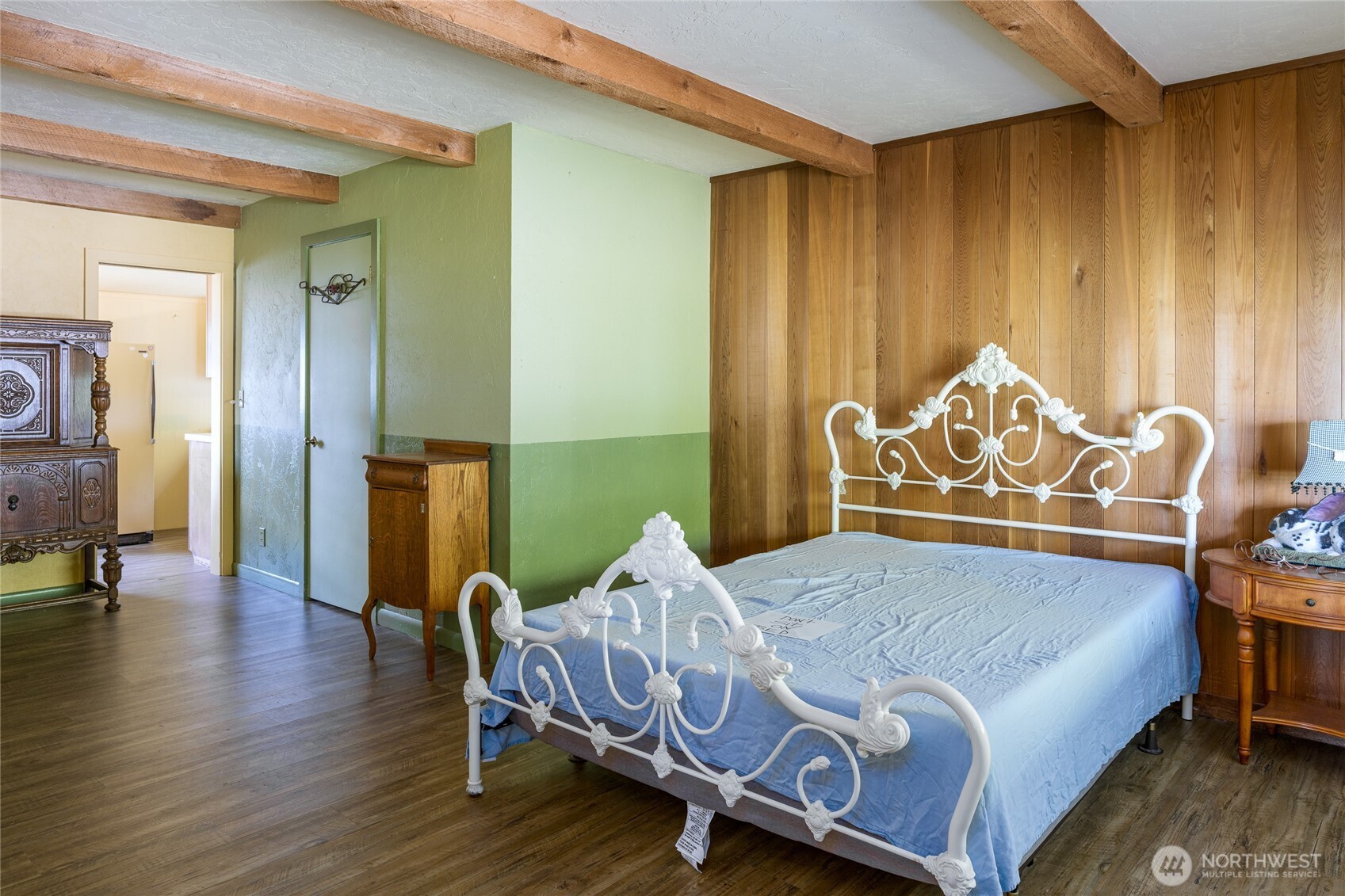 208 Tides End Road Lopez Island, WA 98261 - Photo 18 of 40 a bedroom with a bed and wooden floor