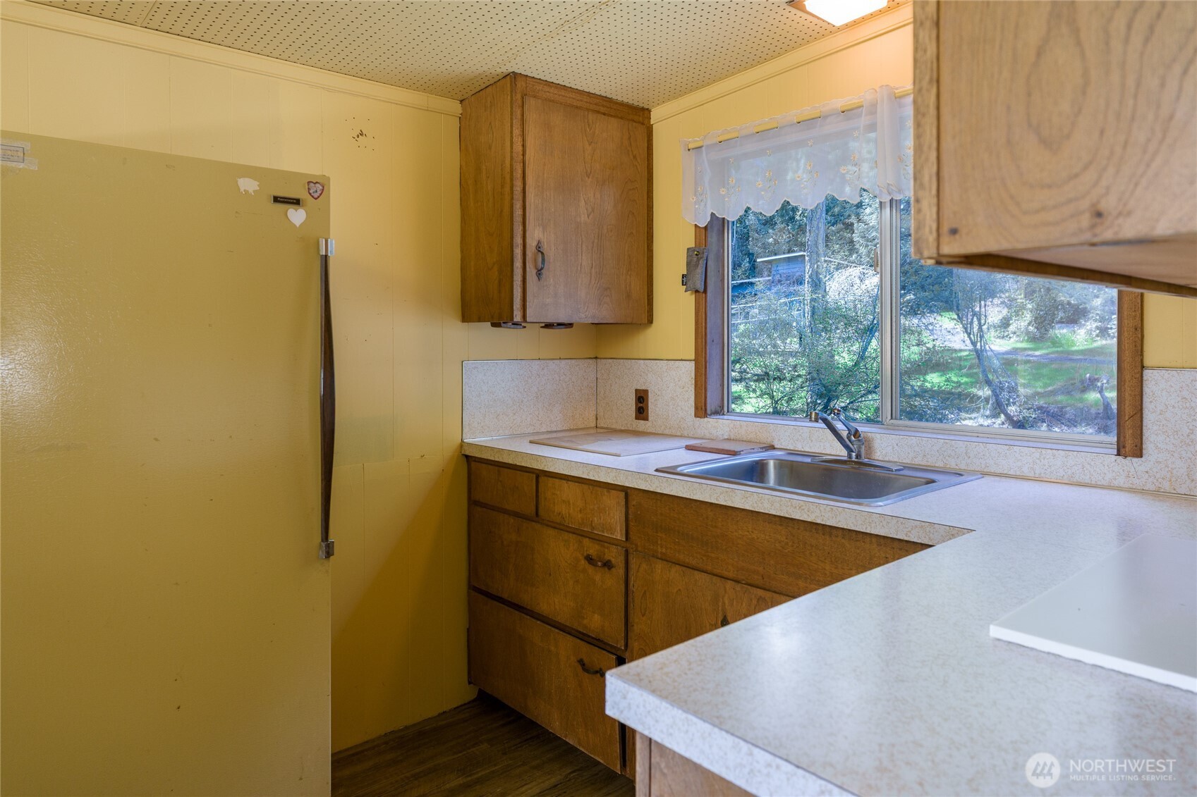 208 Tides End Road Lopez Island, WA 98261 - Photo 19 of 40 a view of a kitchen with a sink and cabinets