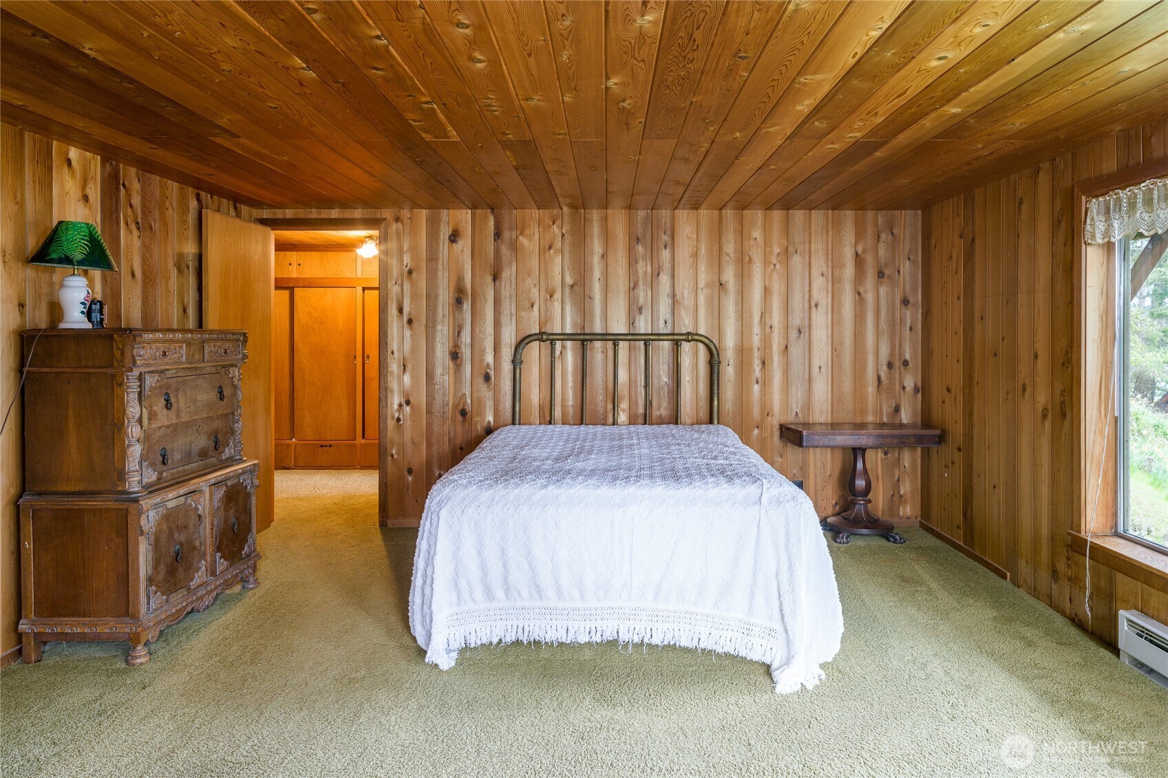 208 Tides End Road Lopez Island, WA 98261 - Photo 20 of 40 a bedroom with a bed and large window