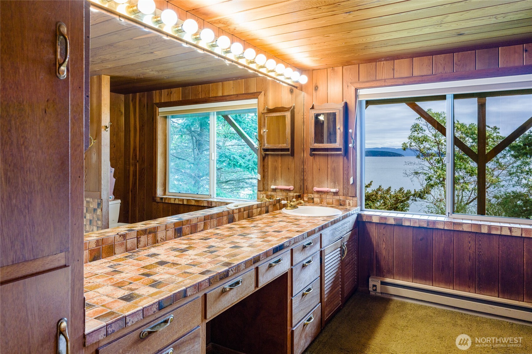 208 Tides End Road Lopez Island, WA 98261 - Photo 21 of 40 a bathroom with a granite countertop sink and a large mirror