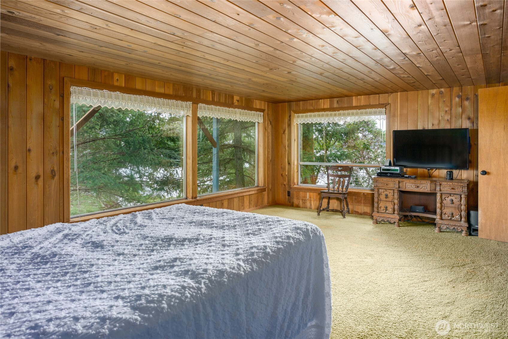 208 Tides End Road Lopez Island, WA 98261 - Photo 23 of 40 a bed room with a bed and flat screen tv