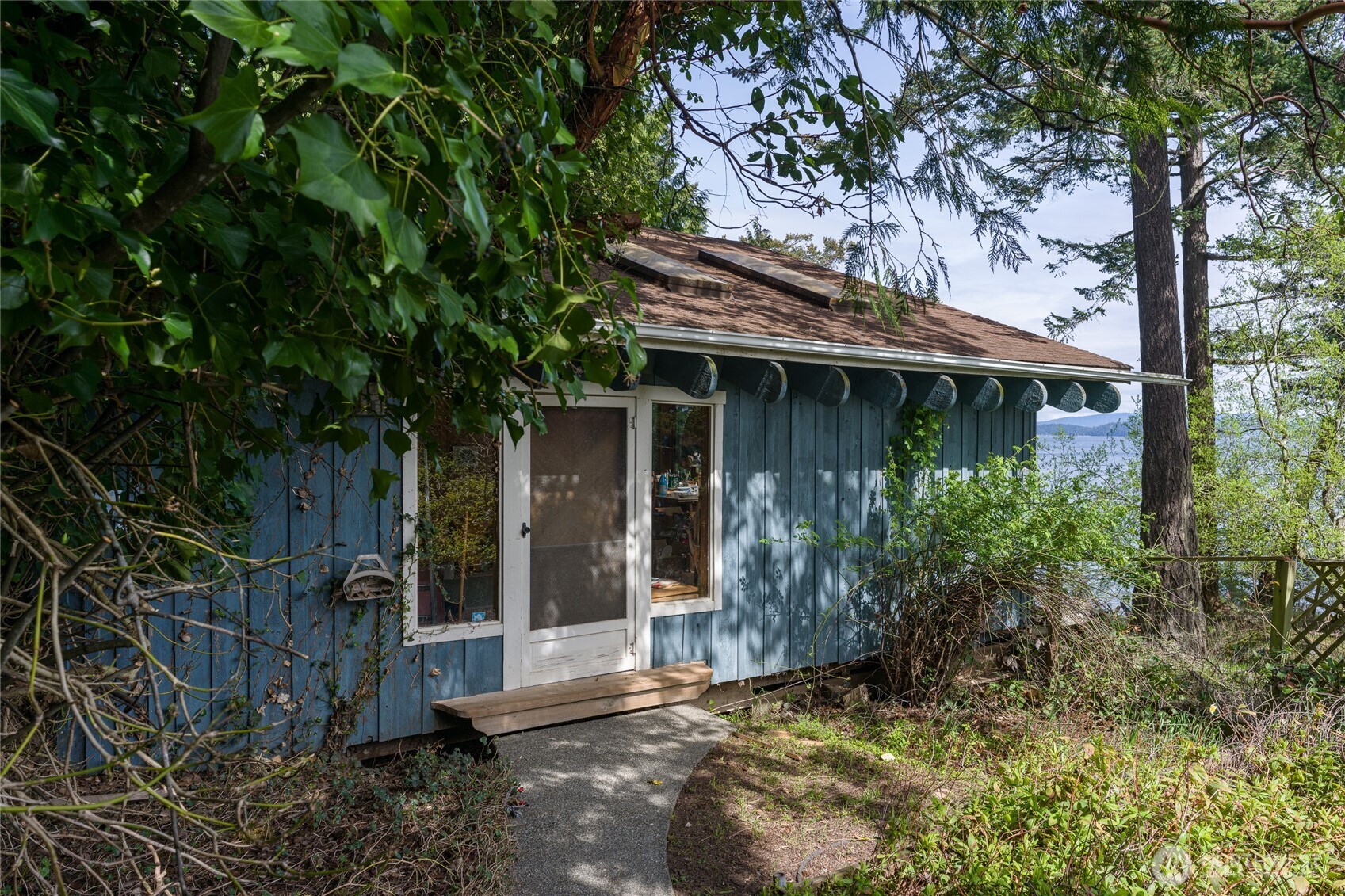208 Tides End Road Lopez Island, WA 98261 - Photo 27 of 40 a view of a house with a tree in front of it