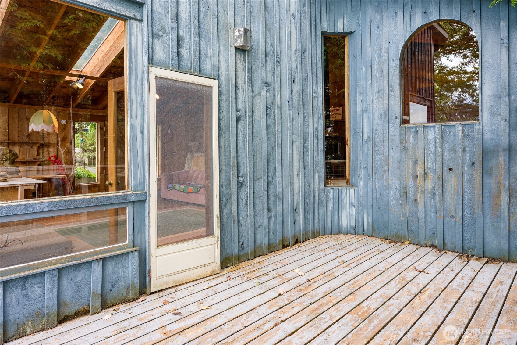 208 Tides End Road Lopez Island, WA 98261 - Photo 28 of 40 a bedroom with a bed and wooden floor