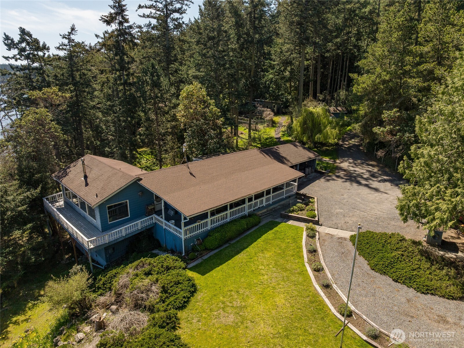 208 Tides End Road Lopez Island, WA 98261 - Photo 5 of 40 an aerial view of a house with swimming pool and large trees