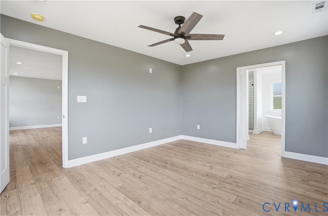 7839 King William Road Aylett, VA 23009 - Photo 18 of 38 a view of a livingroom with a hardwood floor and a ceiling fan