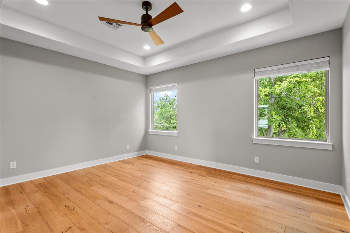 913 Stobaugh Street, Unit B Austin, TX 78757 - Photo 30 of 40 Naturally illuminated by dual windows, this large 2nd floor bonus room features warm wood flooring, coffered ceiling and a classic ceiling fan.