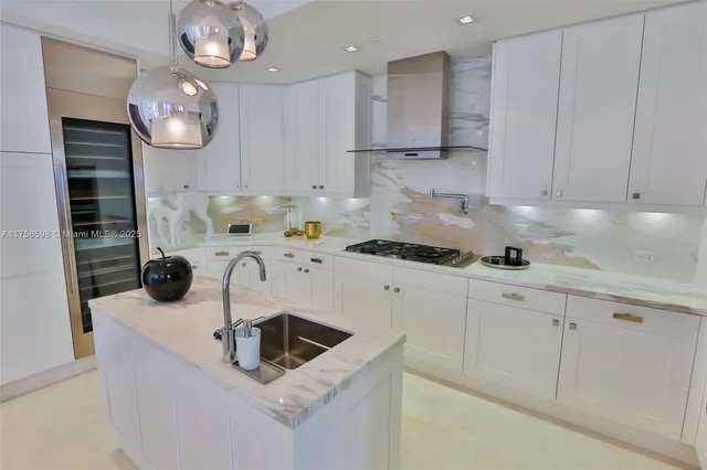 a kitchen with kitchen island granite countertop a sink cabinets and stainless steel appliances