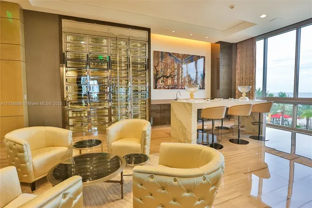 a living room with furniture and a floor to ceiling window