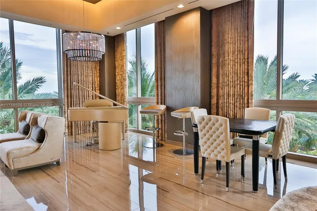 a living room with a couch and a potted plant on the wall