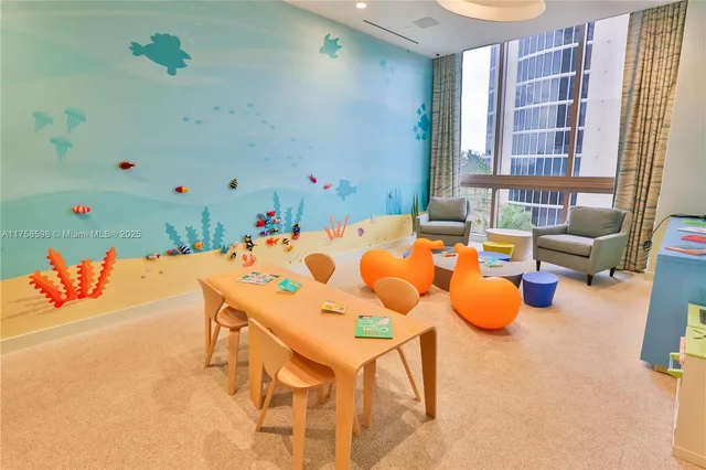 a living room with furniture floor to ceiling window and floor to ceiling window