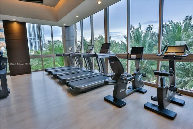 a room with gym equipment and a large window