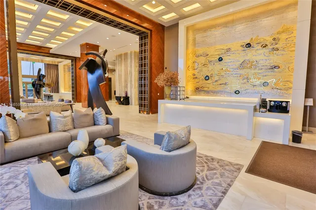 a living room with furniture and large windows