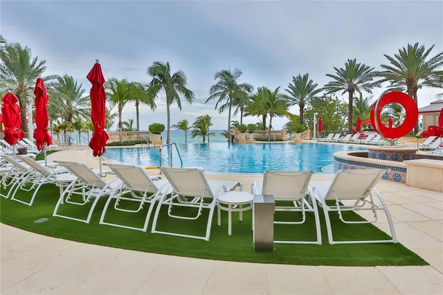a view of swimming pool with outdoor seating