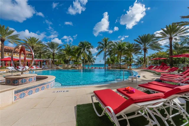 a view of a house with swimming pool and sitting area