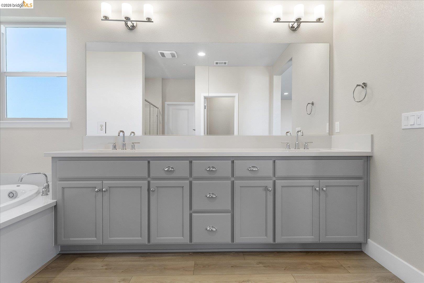 5601 Ridgepoint Way Antioch, CA 94531 - Photo 39 of 59 Dual vanity featuring light gray cabinetry, chrome hardware, undermount sinks, and a large integrated mirror