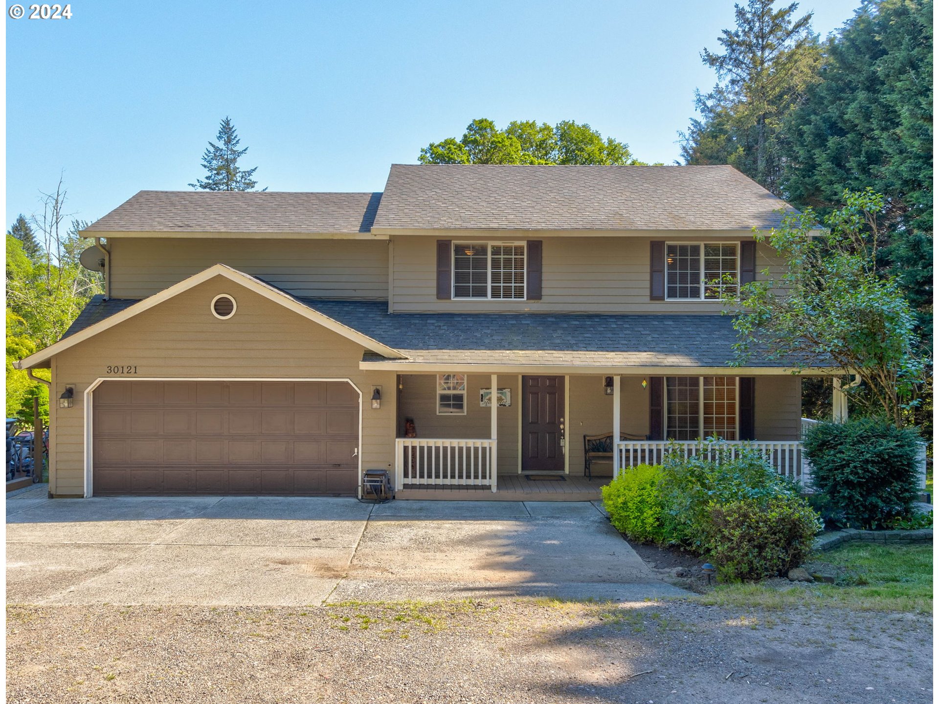 30121 Northeast Harrison Road Battle Ground, WA 98604 - Photo 1 of 40 a front view of a house with a yard and garage