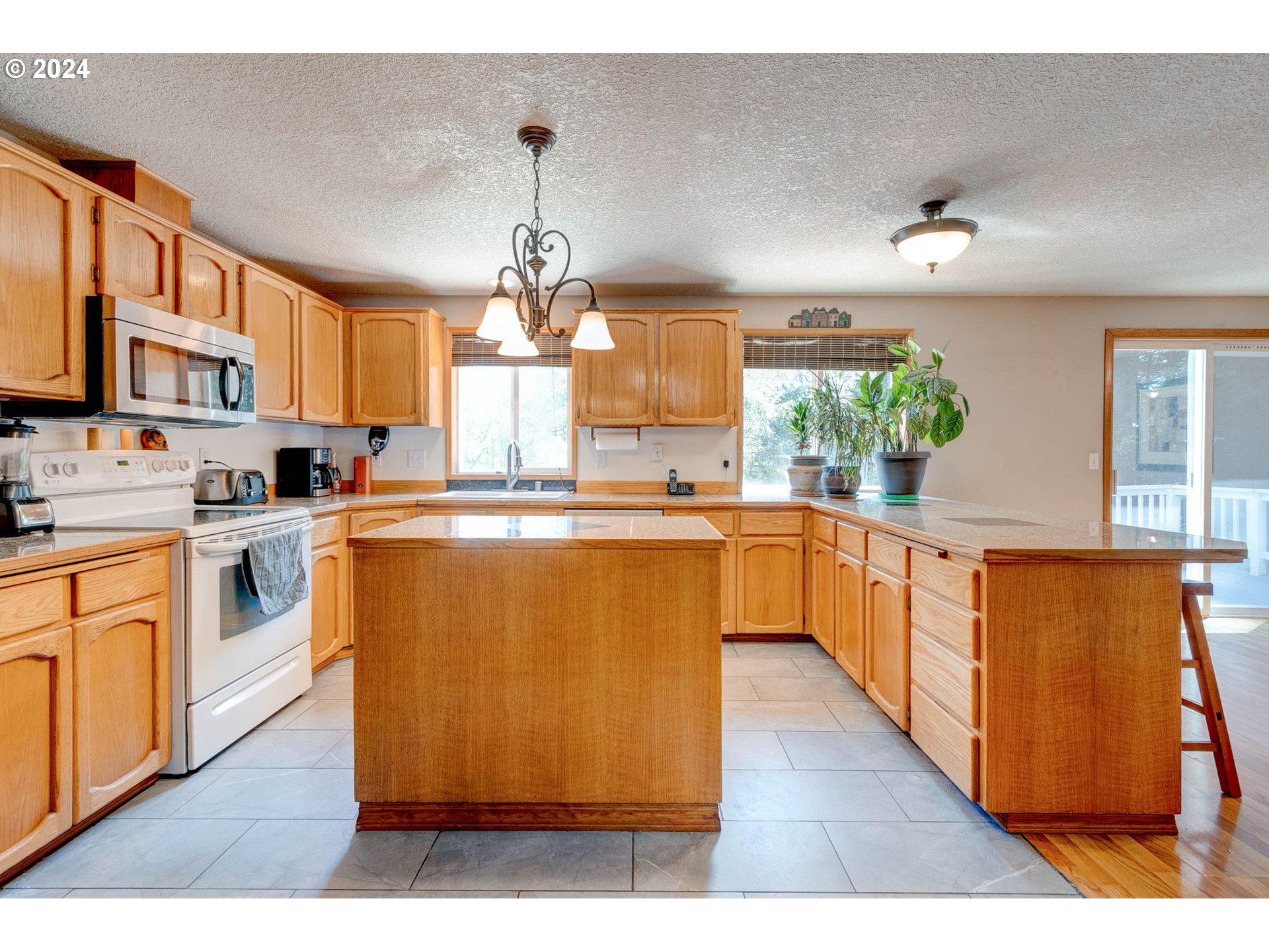 30121 Northeast Harrison Road Battle Ground, WA 98604 - Photo 13 of 40 a kitchen with counter top space a sink appliances and cabinets