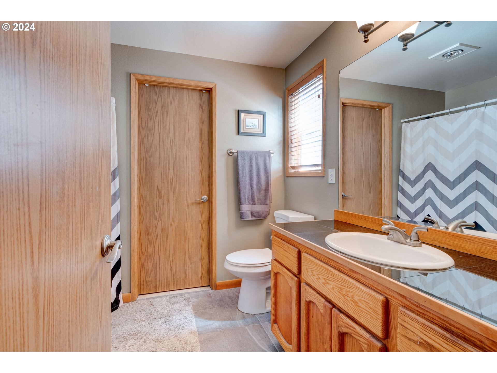 30121 Northeast Harrison Road Battle Ground, WA 98604 - Photo 19 of 40 a bathroom with a granite countertop sink toilet and shower