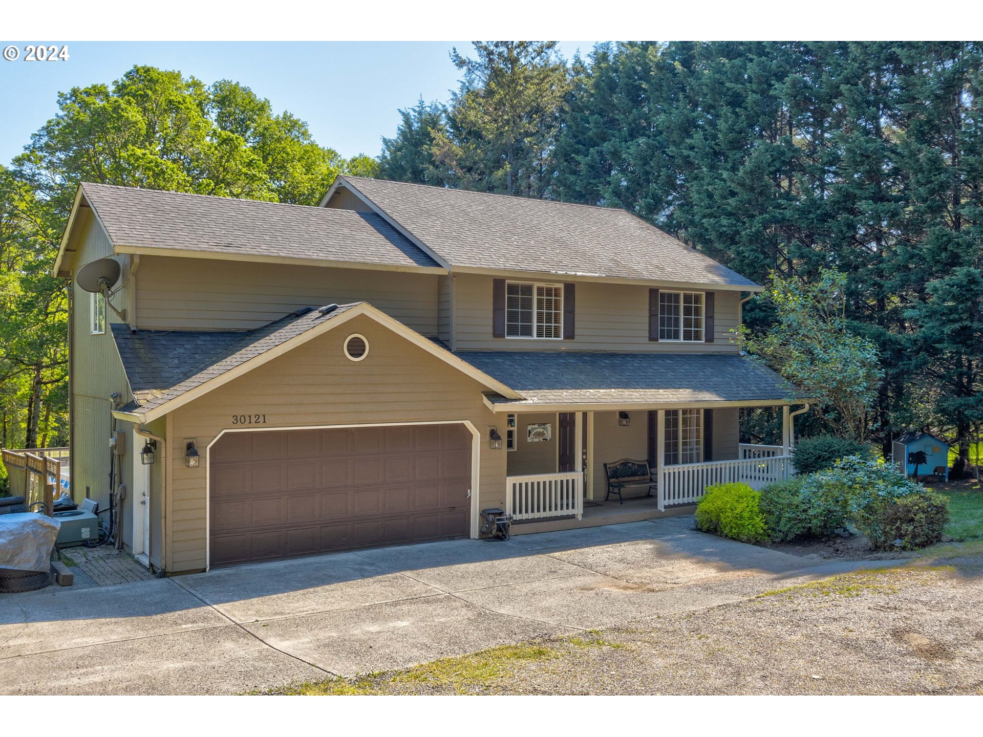 30121 Northeast Harrison Road Battle Ground, WA 98604 - Photo 2 of 40 a front view of a house with a garden and plants