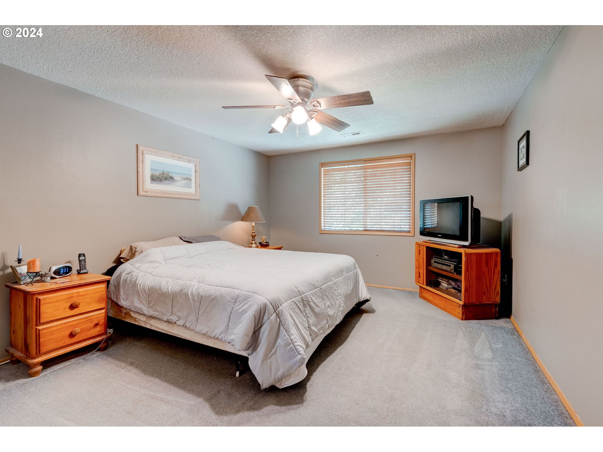 30121 Northeast Harrison Road Battle Ground, WA 98604 - Photo 21 of 40 a spacious bedroom with a bed and a flat screen tv