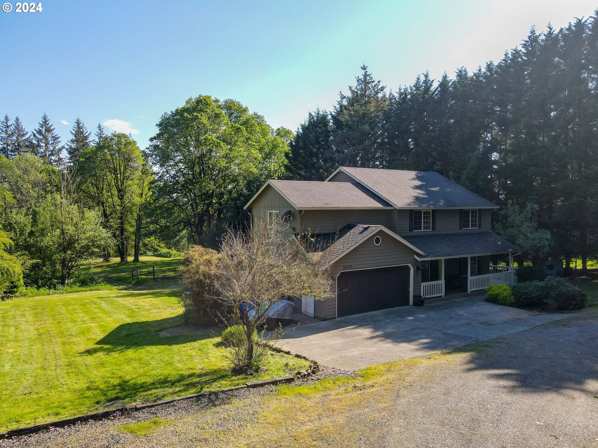 30121 Northeast Harrison Road Battle Ground, WA 98604 - Photo 4 of 40 a front view of a house with a yard garage and outdoor seating