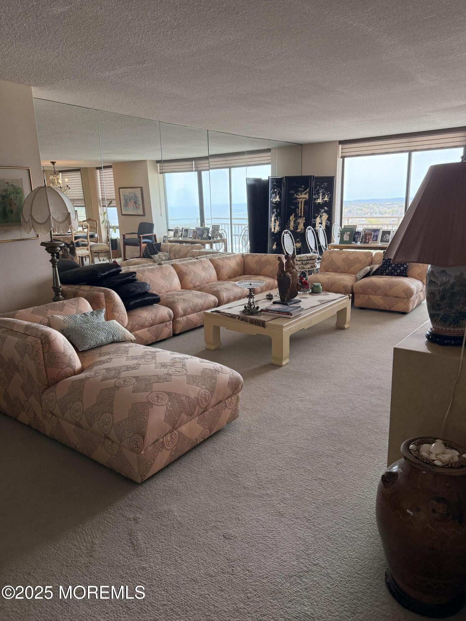 787 Ocean Avenue, Unit 1414 Long Branch, NJ 07740 - Photo 1 of 10 a living room with furniture and a large window