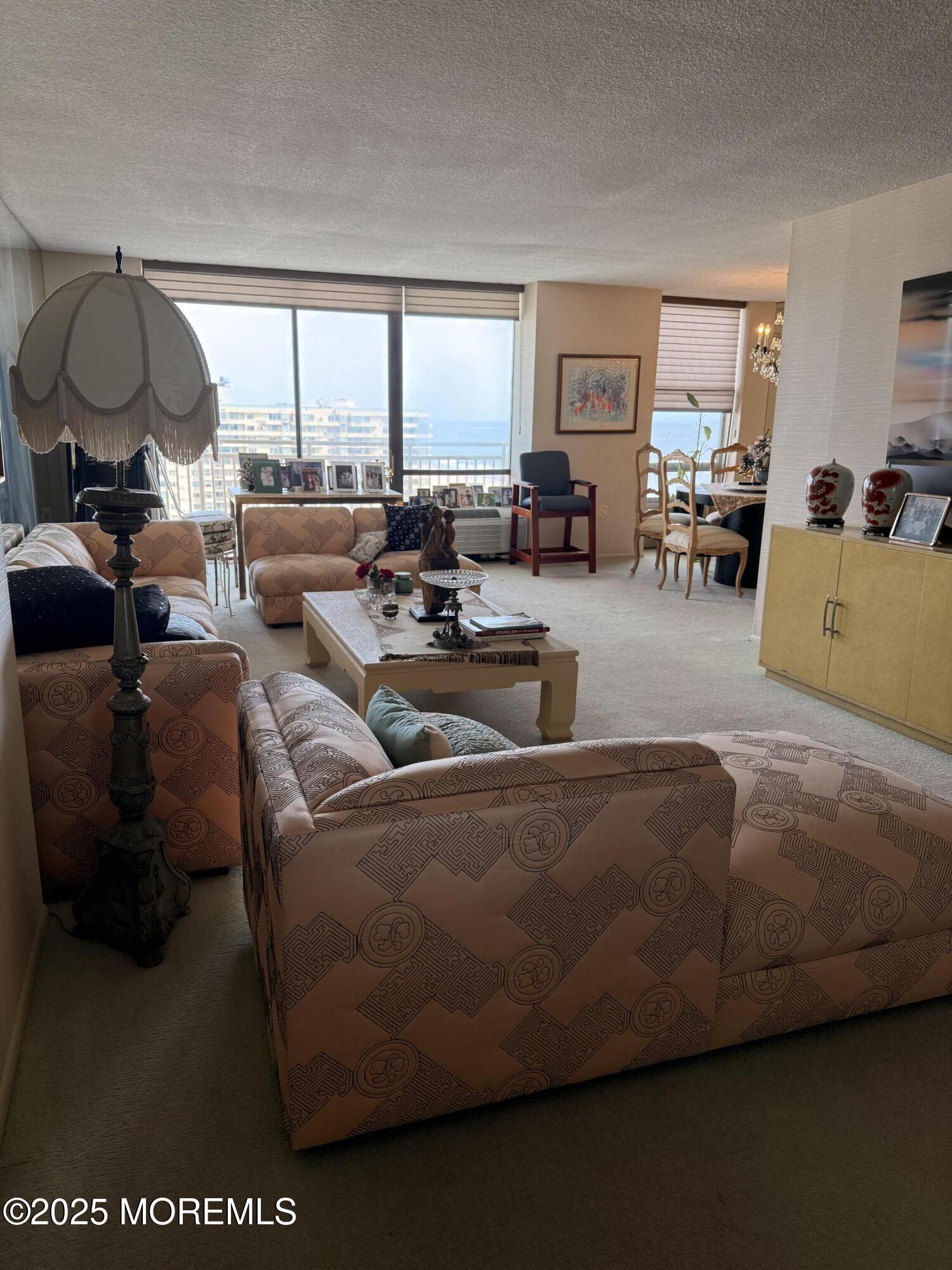 787 Ocean Avenue, Unit 1414 Long Branch, NJ 07740 - Photo 2 of 10 a living room with furniture and a large window