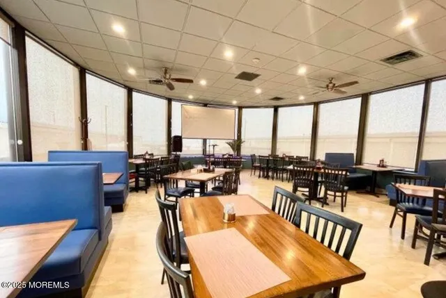 a living room with lots of furniture and a floor to ceiling window