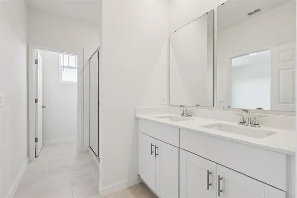 a white toilet sitting next to a white wall