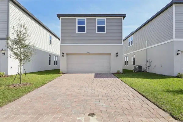 a front view of a house with a yard and garage