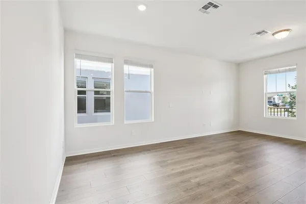 a view of kitchen with wooden floor and electronic appliances