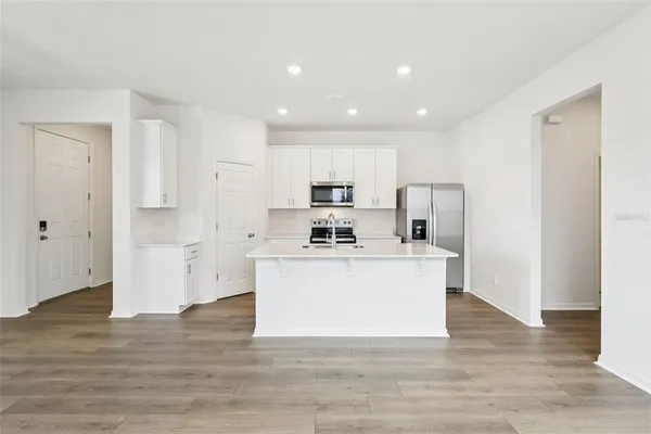 a view of a kitchen with wooden floor
