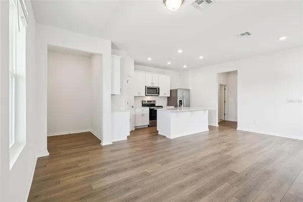 a kitchen with stainless steel appliances a refrigerator stove microwave and sink