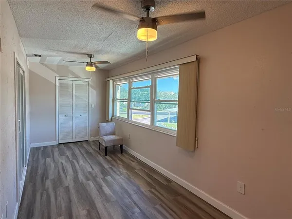 a view of a room with wooden floor and windows