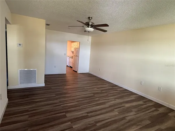 a view of an empty room and wooden floor