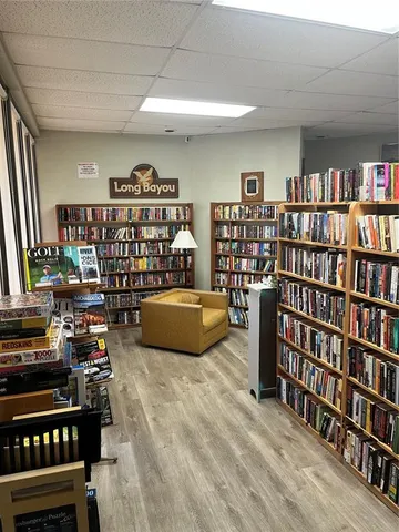 a living room with couches and kitchen view