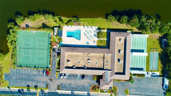 an aerial view of a house with swimming pool and ocean view