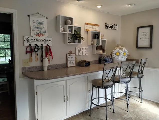 a view of a dining room with furniture and chandelier