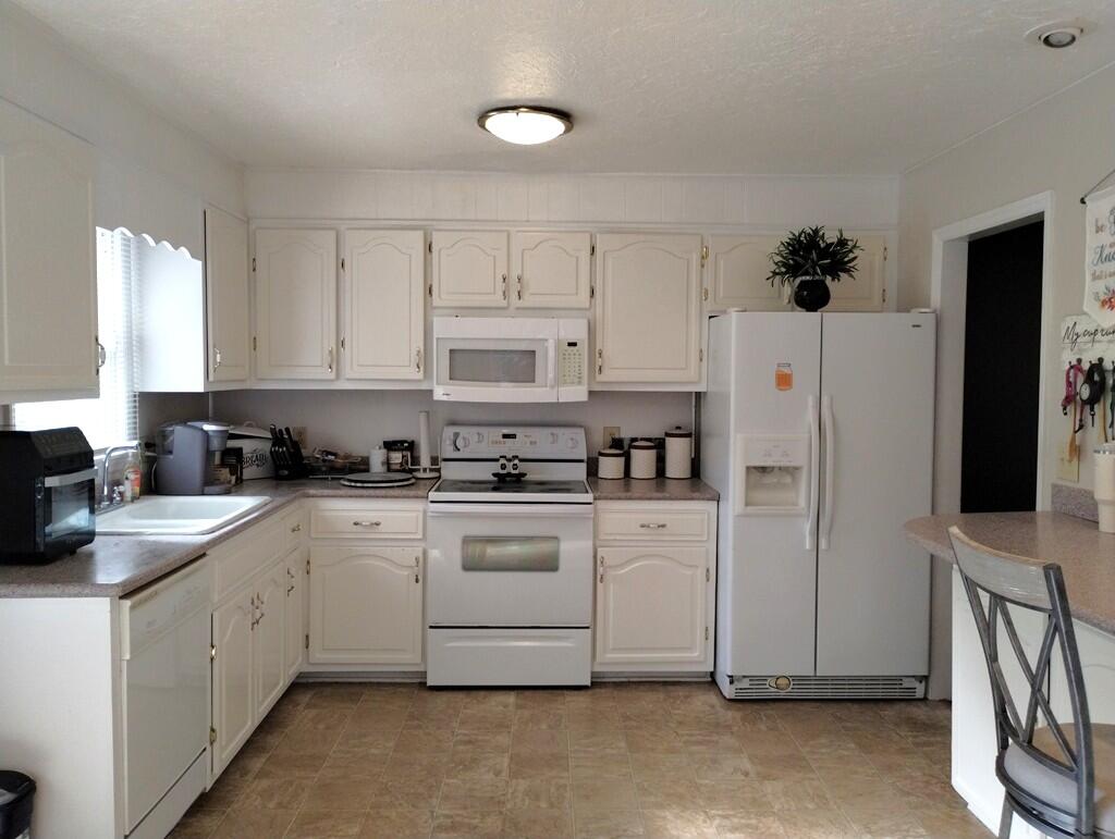 227 Vista View Lane Ridgeway, VA 24148 - Photo 13 of 45 a kitchen with white cabinets and white appliances