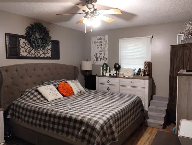 a bedroom with bed and a chandelier