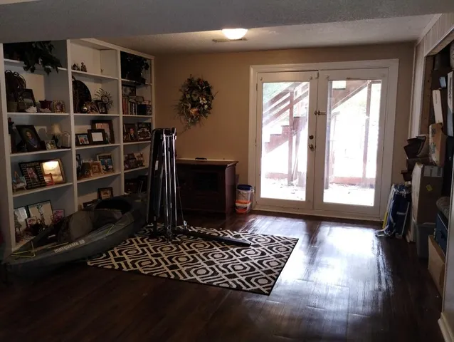a living room with hard wood floor and a fireplace