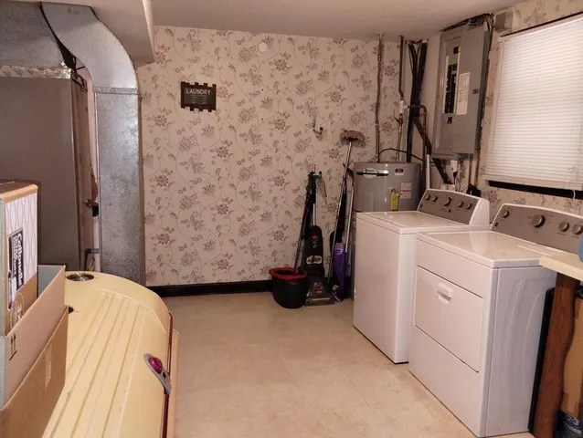 a view of a patio with table and chairs and a barbeque