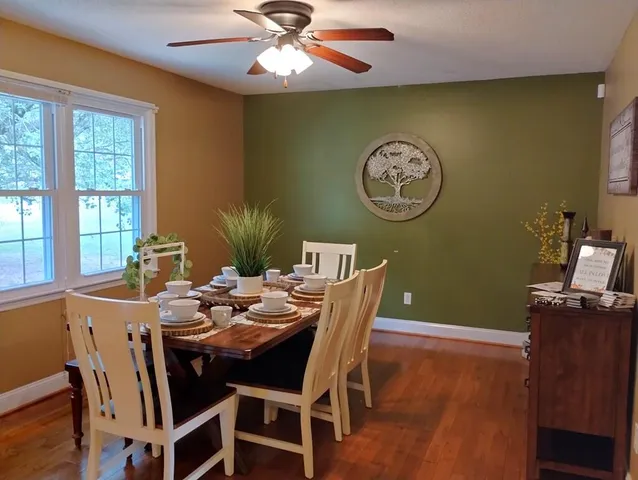 a view of a dining room with furniture window and wooden floor
