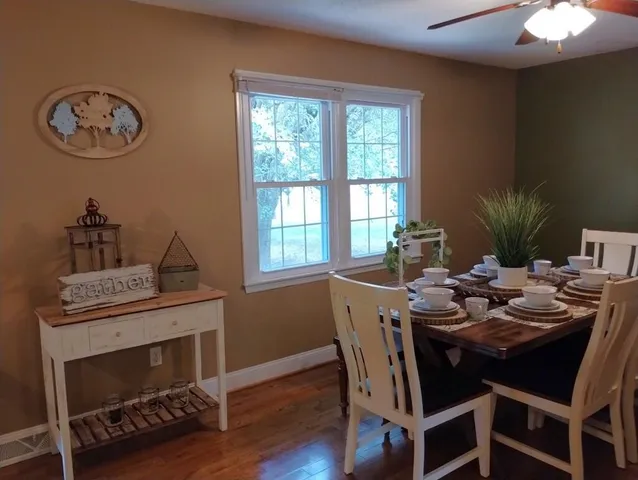 a view of a dining room with furniture window and wooden floor