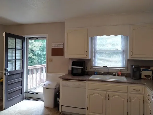 a kitchen with a window a sink and a stove