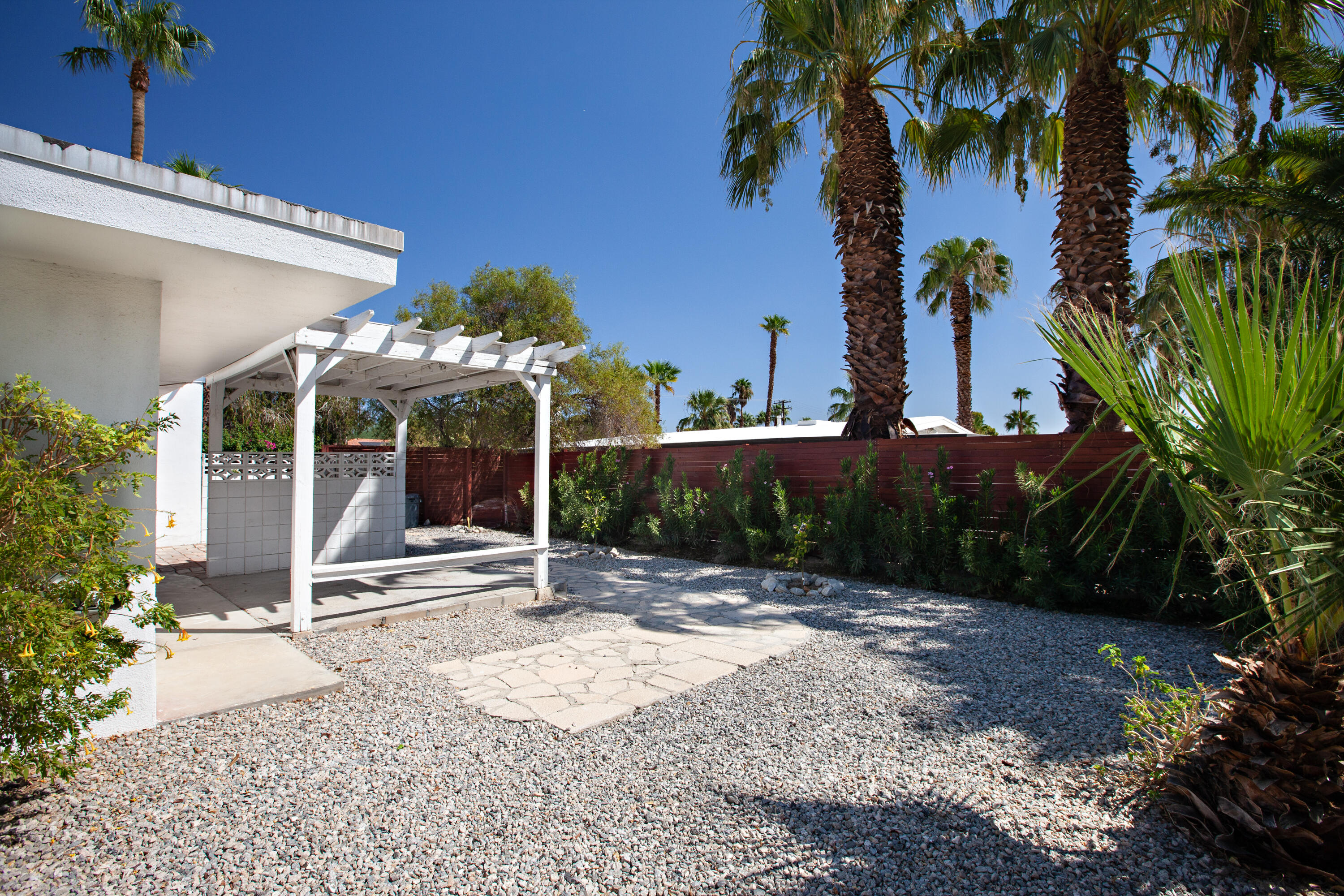 3033 East Verona Road Palm Springs, CA 92262 - Photo 12 of 23 a view of a patio with a table and chairs under an umbrella